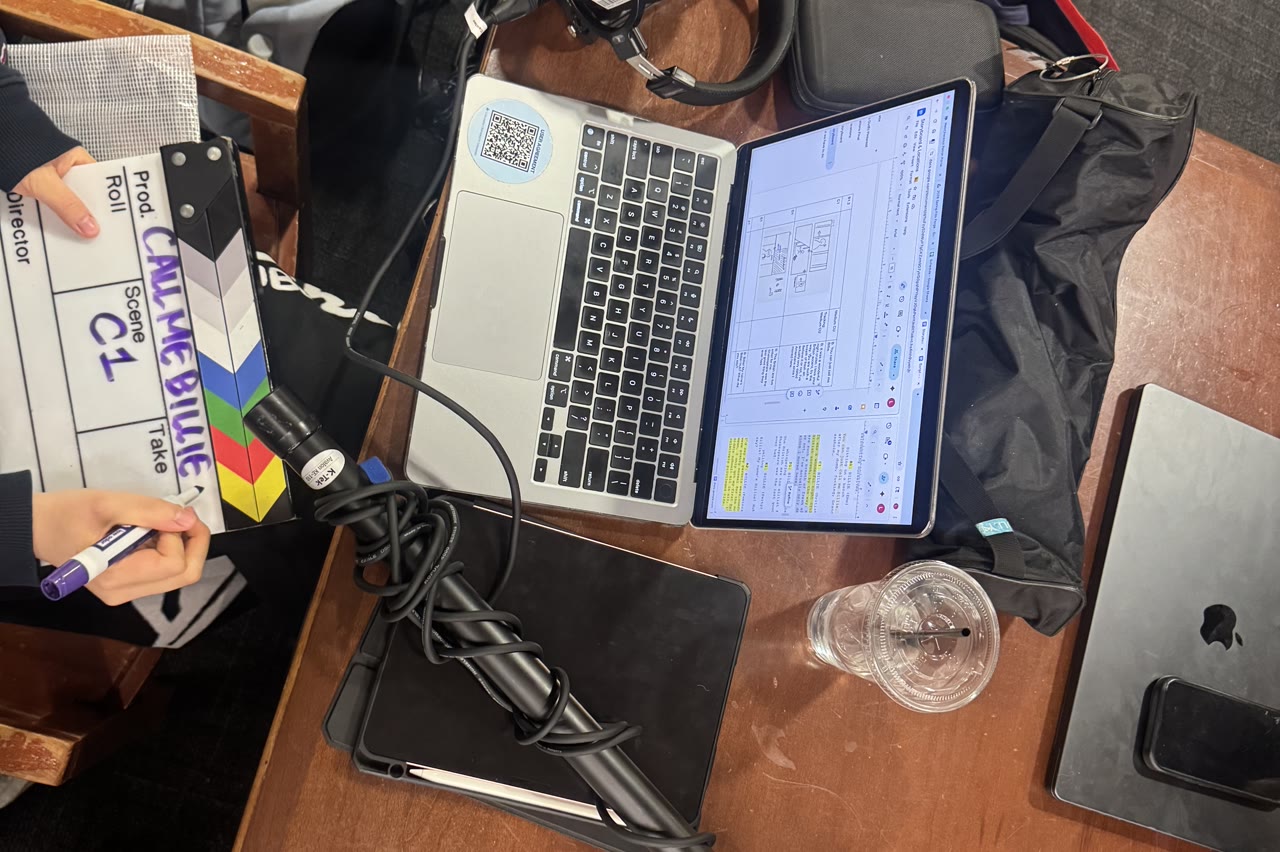 A clapperboard, laptop and headphones laid out on a Studio Passion Projects shoot.